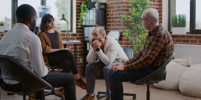 man sitting in a group at the retreat of atlanta discussing alcohol brain fog