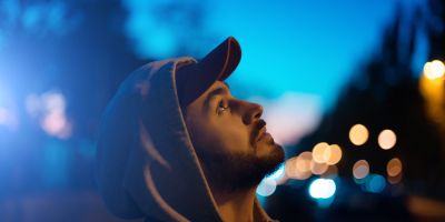 man looking up at his house wondering how he will start his own sober holiday traditions