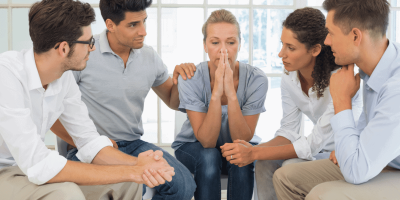 patients in group therapy discussing substance abuse risk of suicide