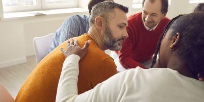 man being consoled in group during his Fentanyl Withdrawal Timeline