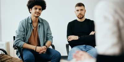 Two men enjoying addiction recovery treatment and learning what makes amphetamines so dangerous.