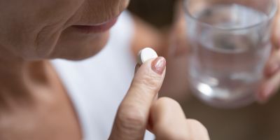 A woman suffering from elderly substance abuse actively abuses prescription medication.