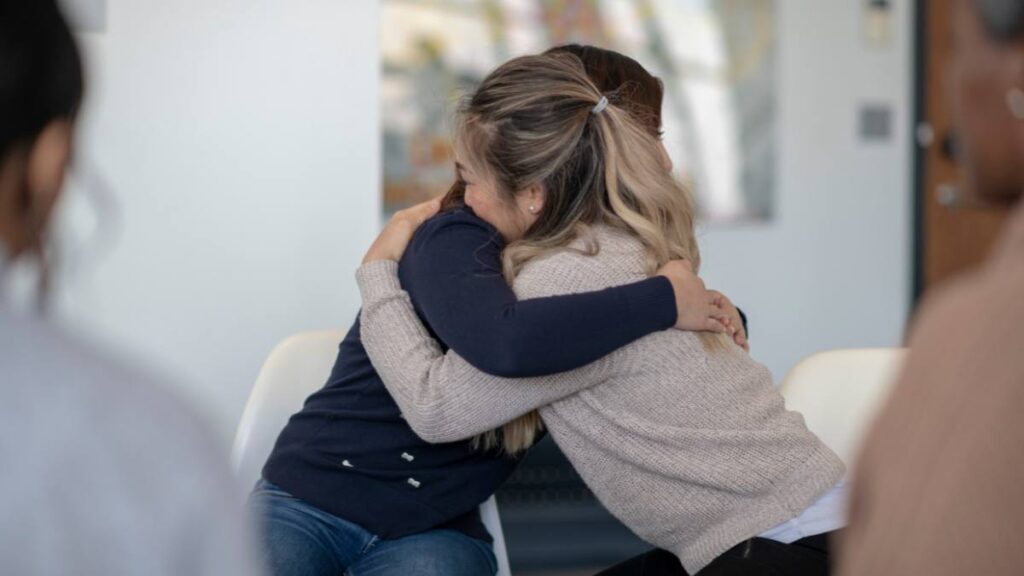 Female patients hugging during peer to peer support, a fundamental activity of cocaine detox in Georgia