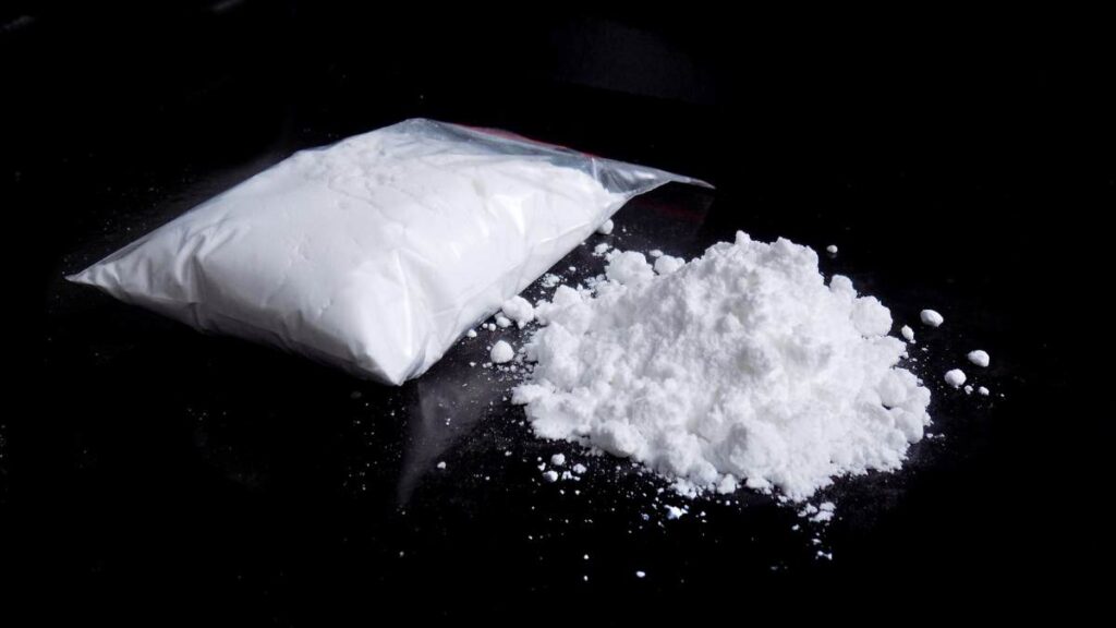 Cocaine powder on a black background; the addiction to the drug demands medical services like cocaine detox in Georgia 
