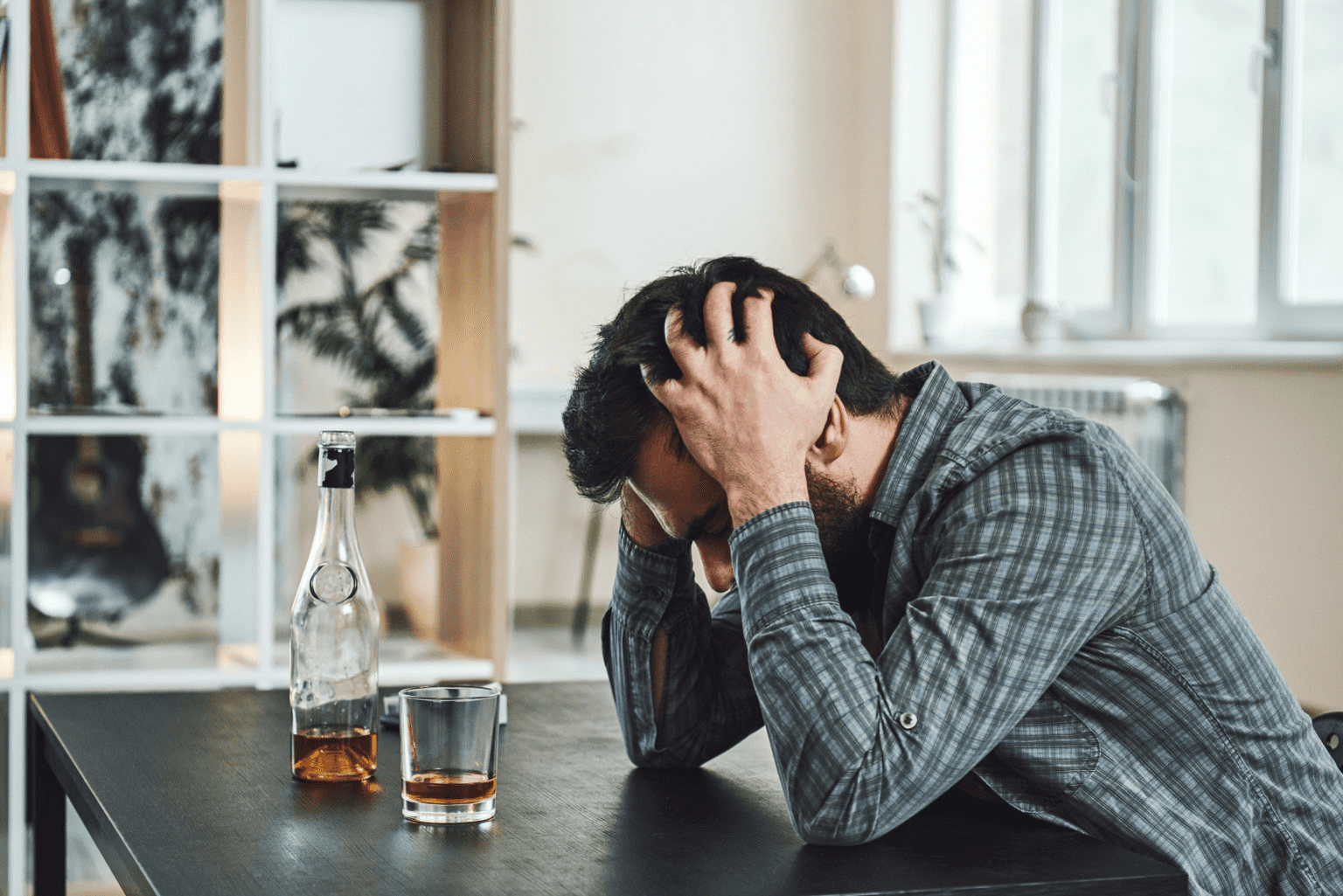 man struggling with an alcohol addiction thinks about detox